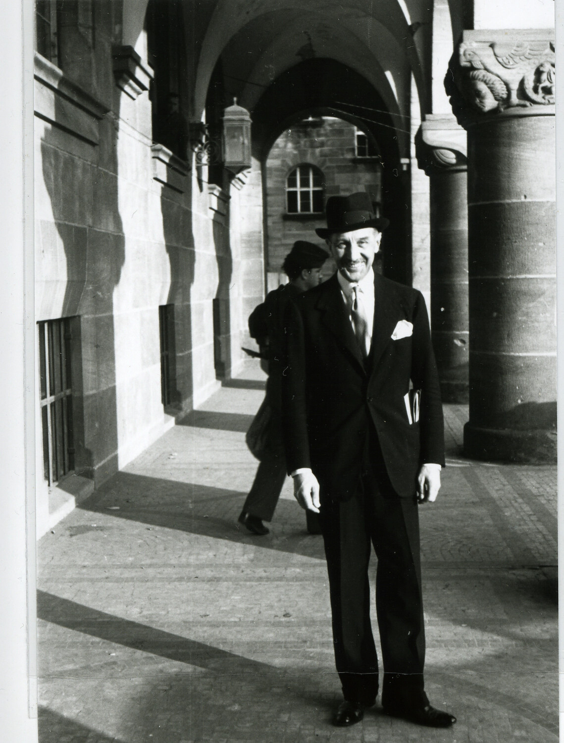 Unidentified Man in Suit and Hat Beneath Stone Archway, Nuremberg Trials Collection, circa 1945-1946