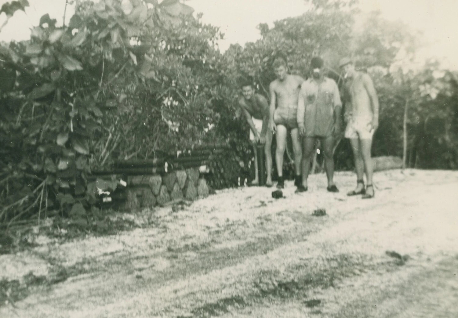 Four Servicemen in Swimwear Beside a Coral Wall, Pacific Theater, WWII (McAleer Collection)
