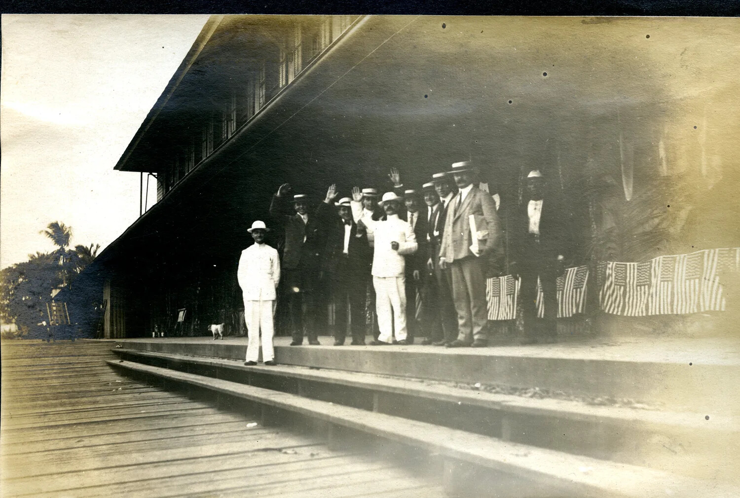 Group Portrait on Dock with American Flags, USS Columbia Album, Early 20th Century Tropical Port Call