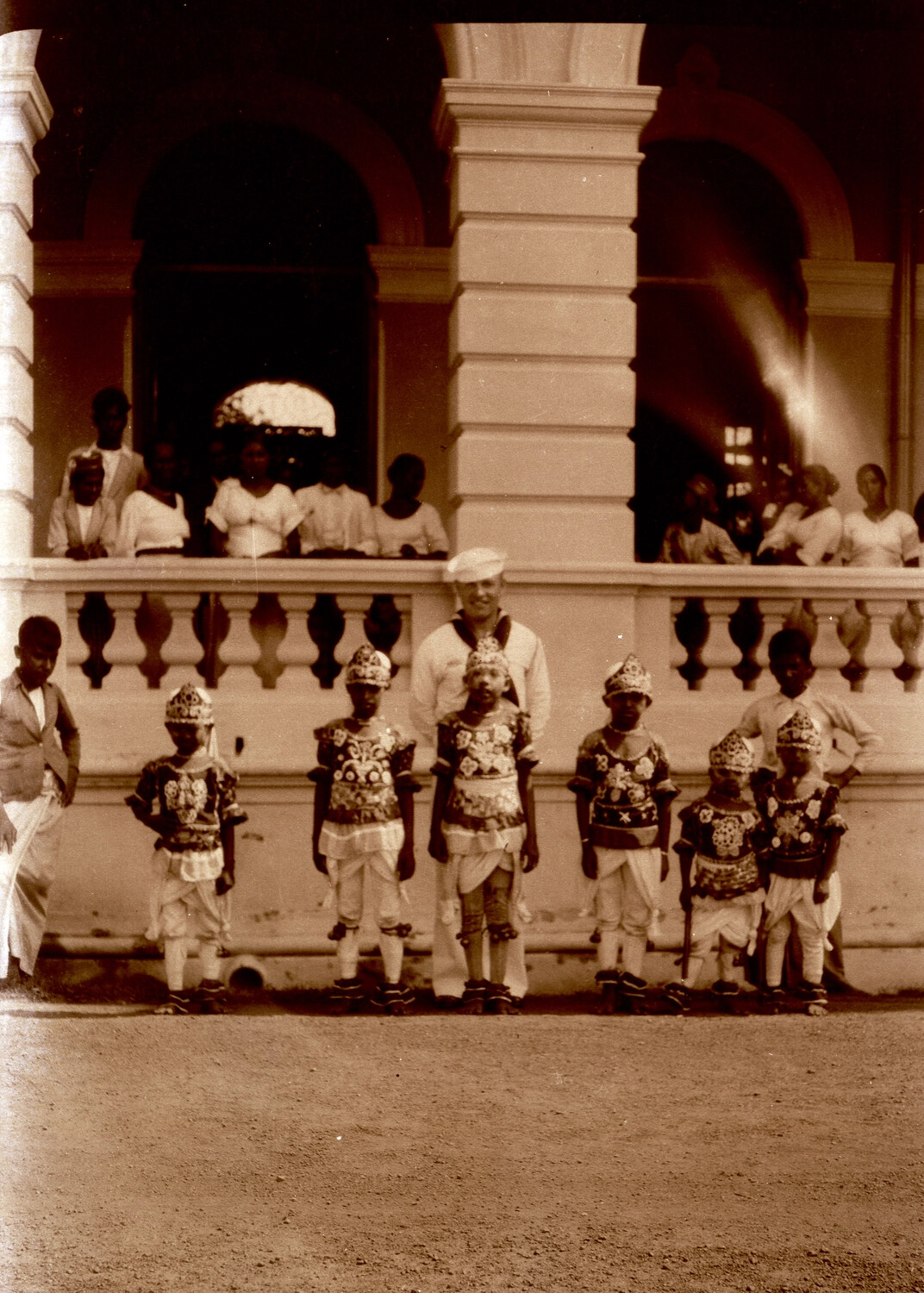 U.S. Navy Sailor with Costumed Children at Colonial-Era Building, Pre-WWII Pacific Port Visit