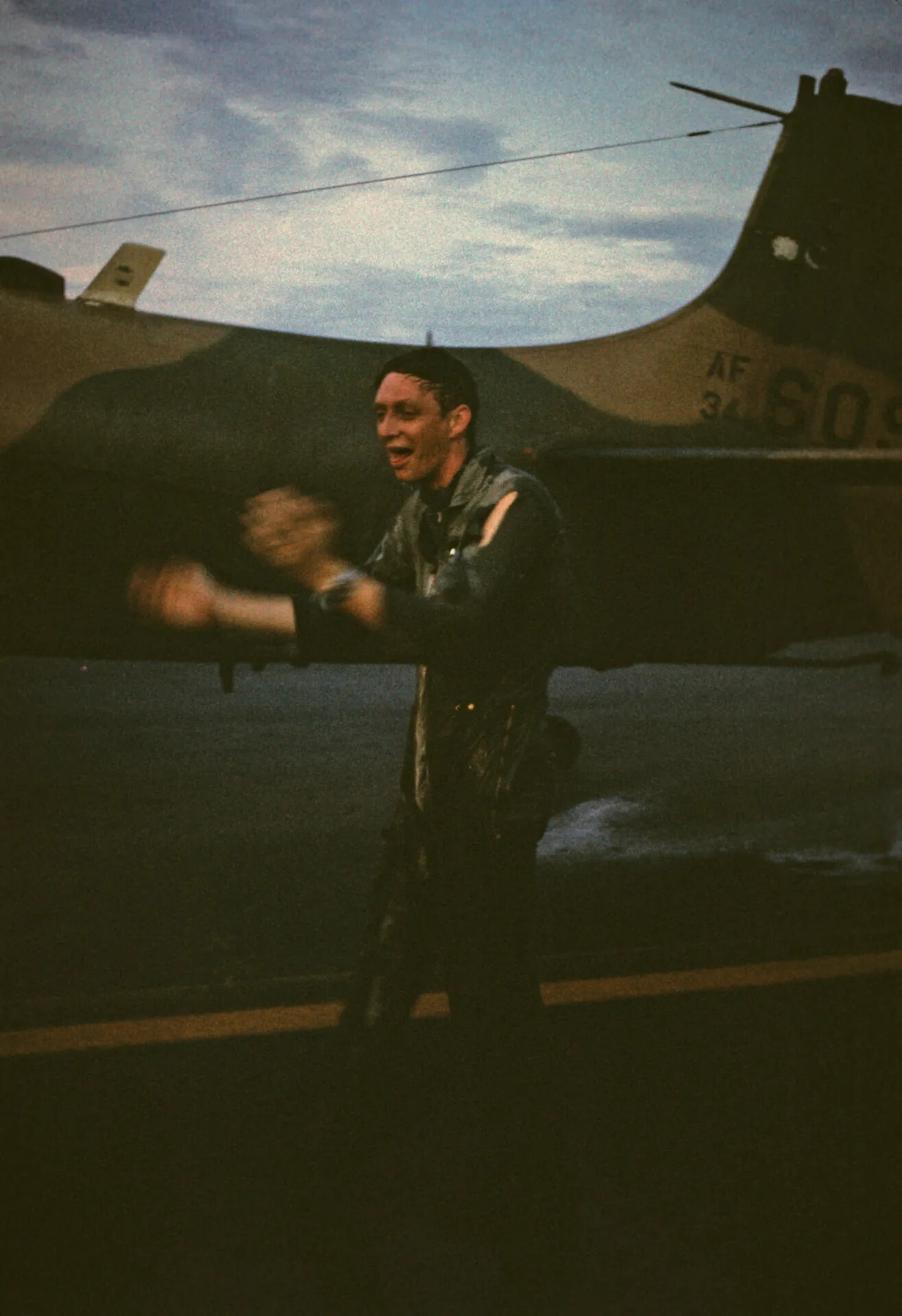USAF Pilot Celebrating on Flight Line at Dusk, Southeast Asia, c. August 1970