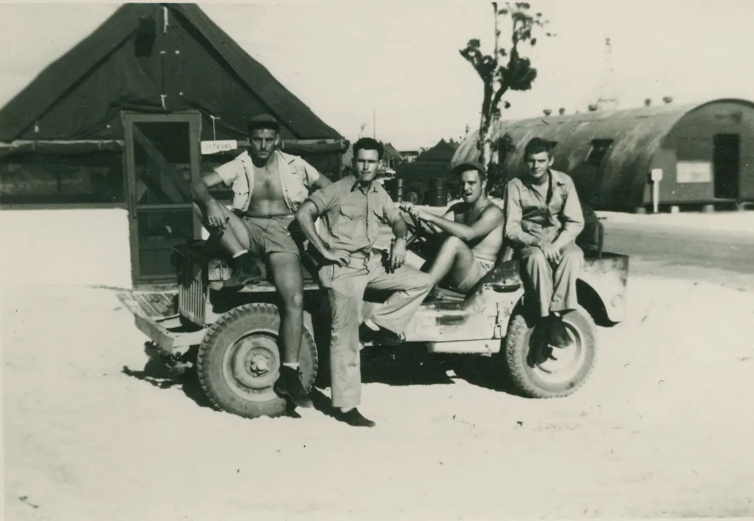 Servicemen Posing on Jeep at Pacific Base Camp, WWII