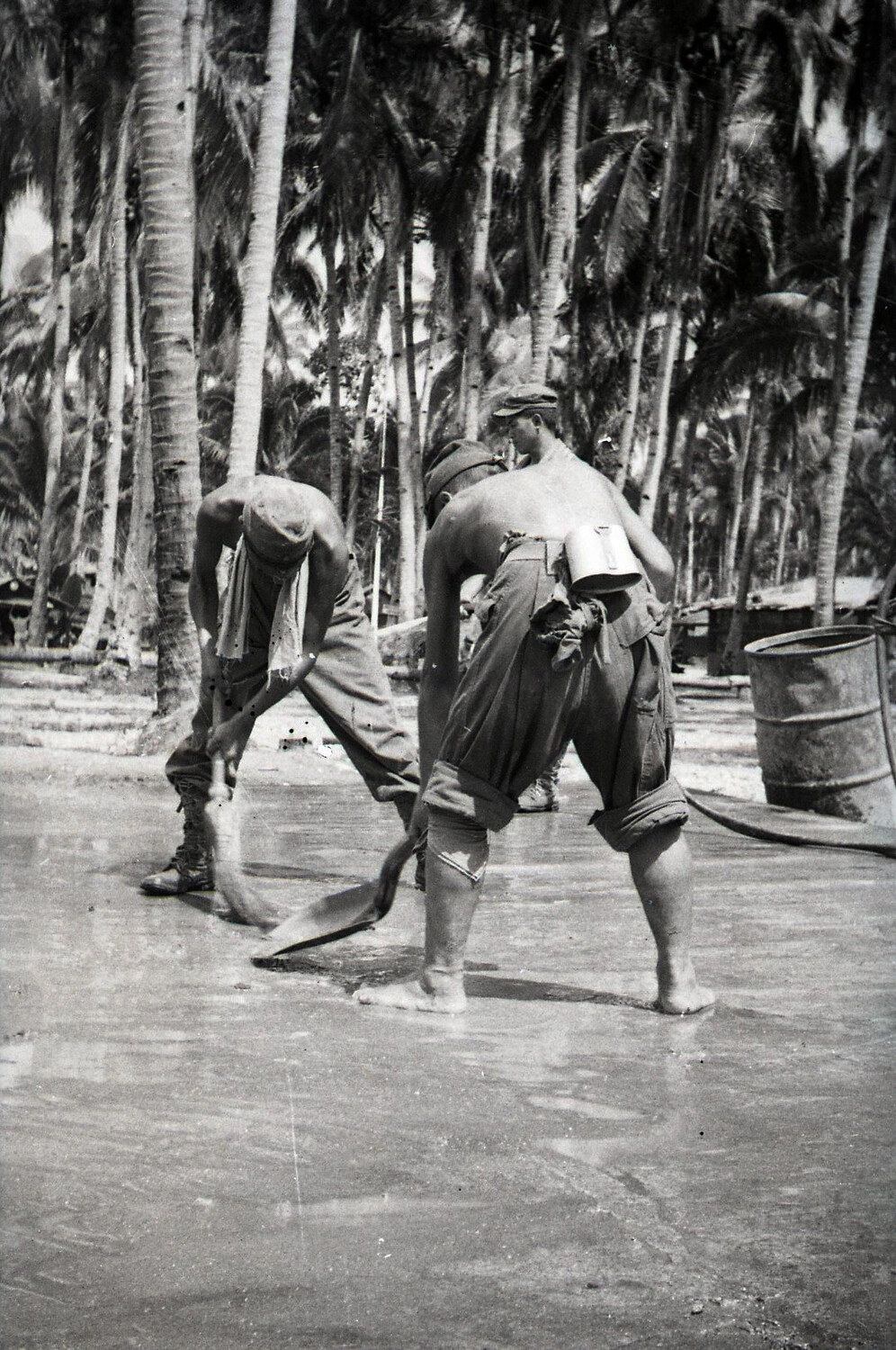 American Servicemen Finishing Wet Concrete Surface Amid Palm Grove, Luzon, Philippines, WWII