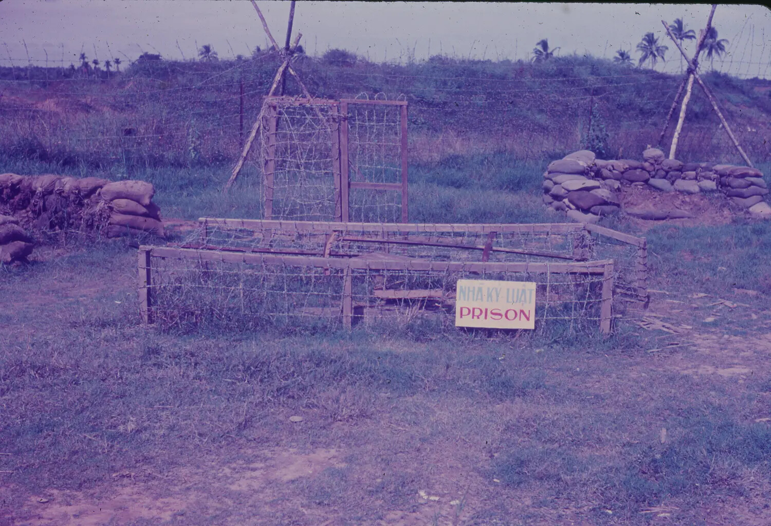 Small Wire-Enclosed "Prison" Holding Pen at a U.S. Air Base Perimeter, South Vietnam, 1965