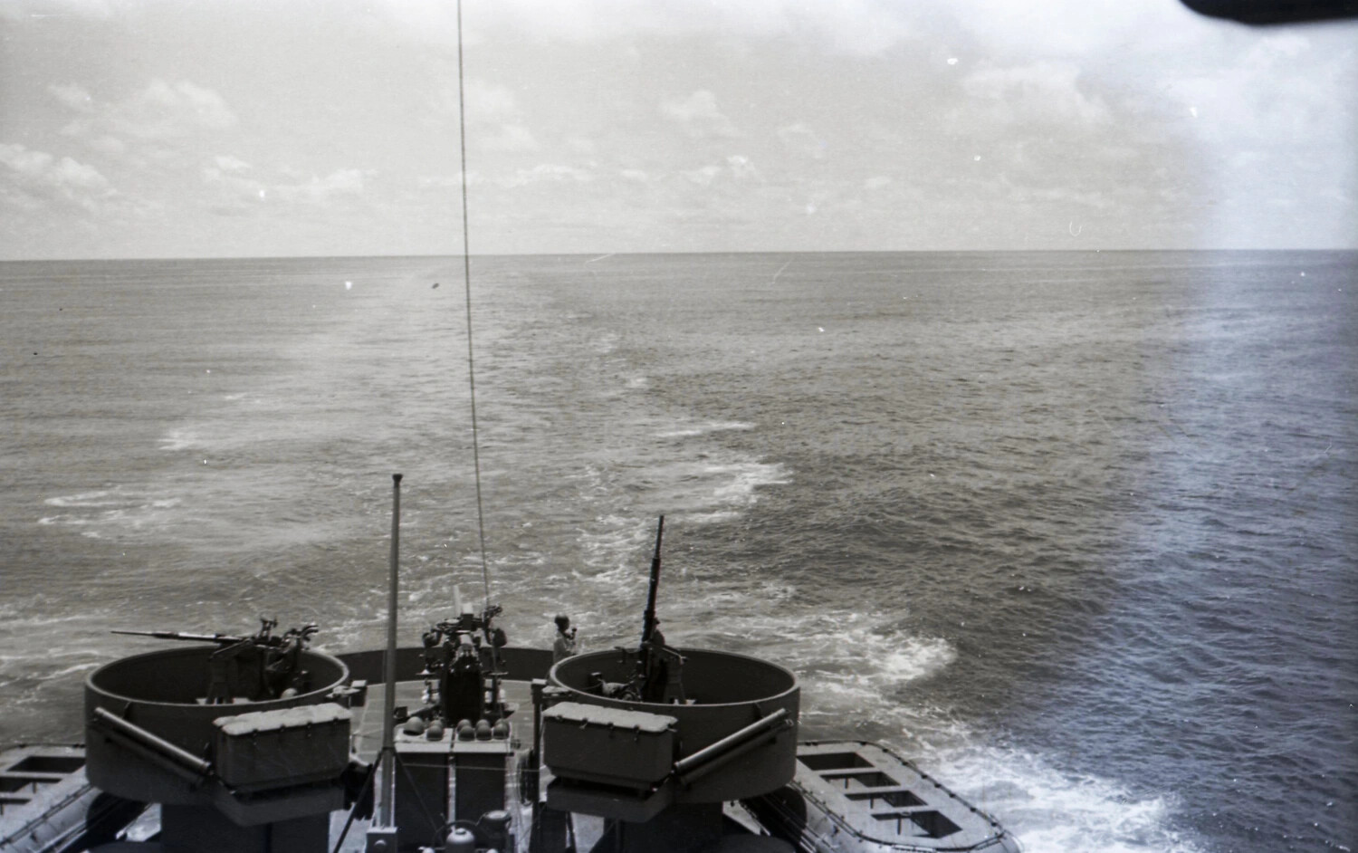 Stern View of Ship with Manned Anti-Aircraft Gun Tubs at Sea, WWII CBI Theater Collection