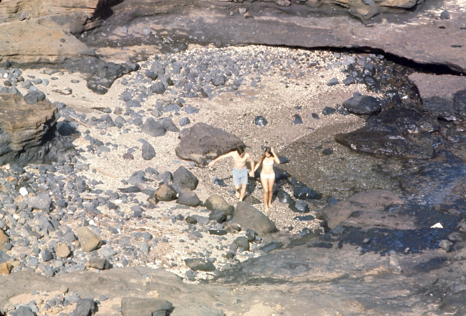 Couple on Volcanic Rock Beach, Pacific Liberty Port (Close View)