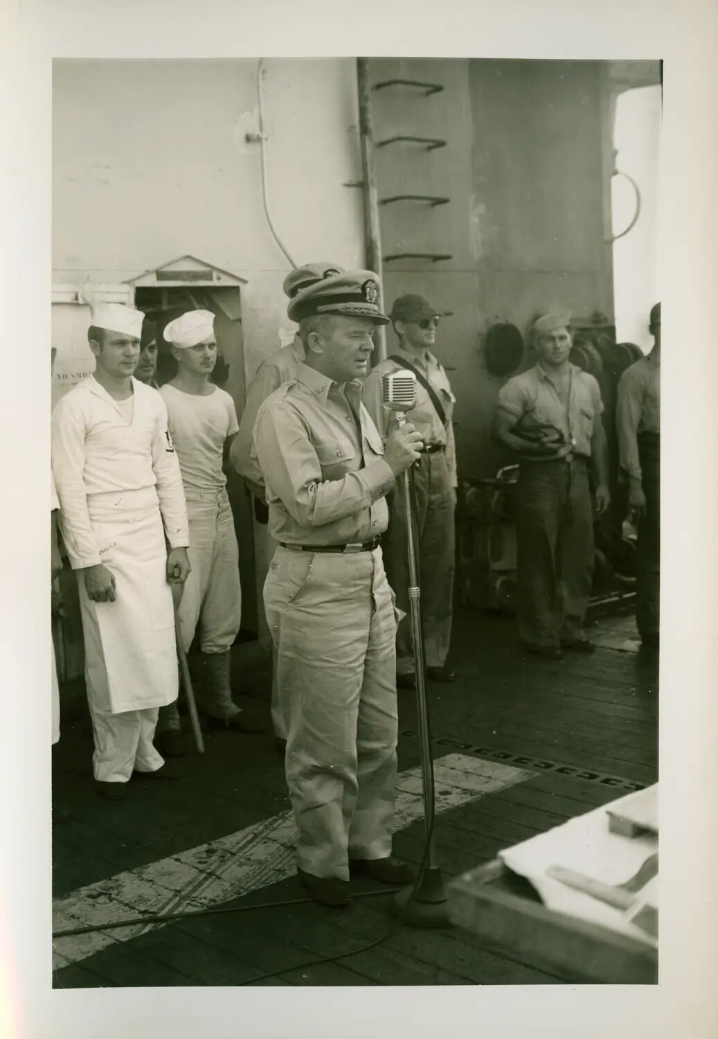 Commanding Officer Addressing Crew Over Microphone Aboard USS Petrof Bay (CVE-80), WWII