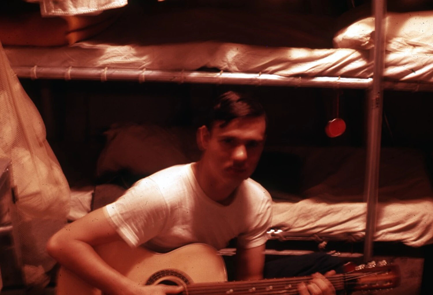 Sailor with Guitar Looking at Camera, Berthing Compartment, USS Ticonderoga, Vietnam War Era