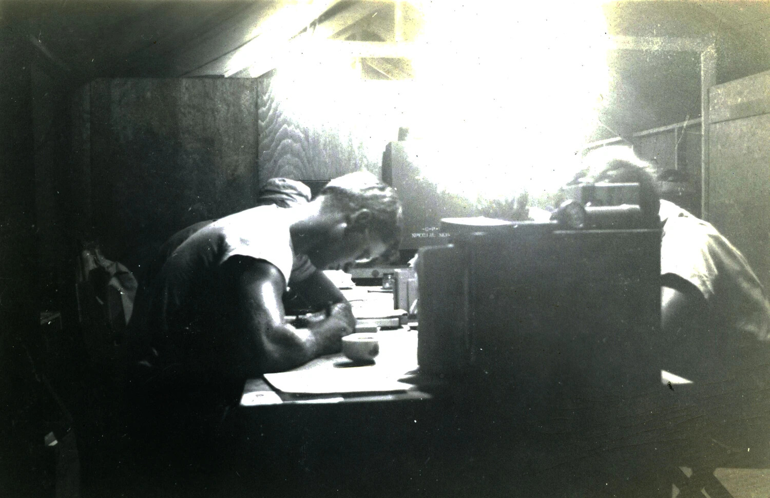 Servicemen at Work Inside Tent Interior, Backlit, WWII Pacific Theater