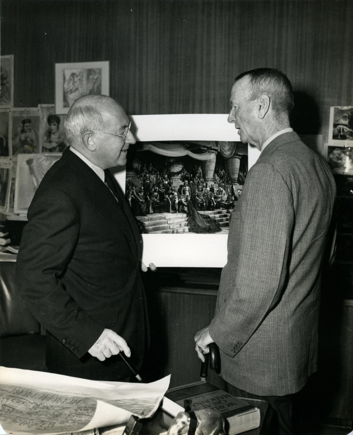 Two Men Examining a Framed Illustration in a Study, Wainwright Photo Album, 1949