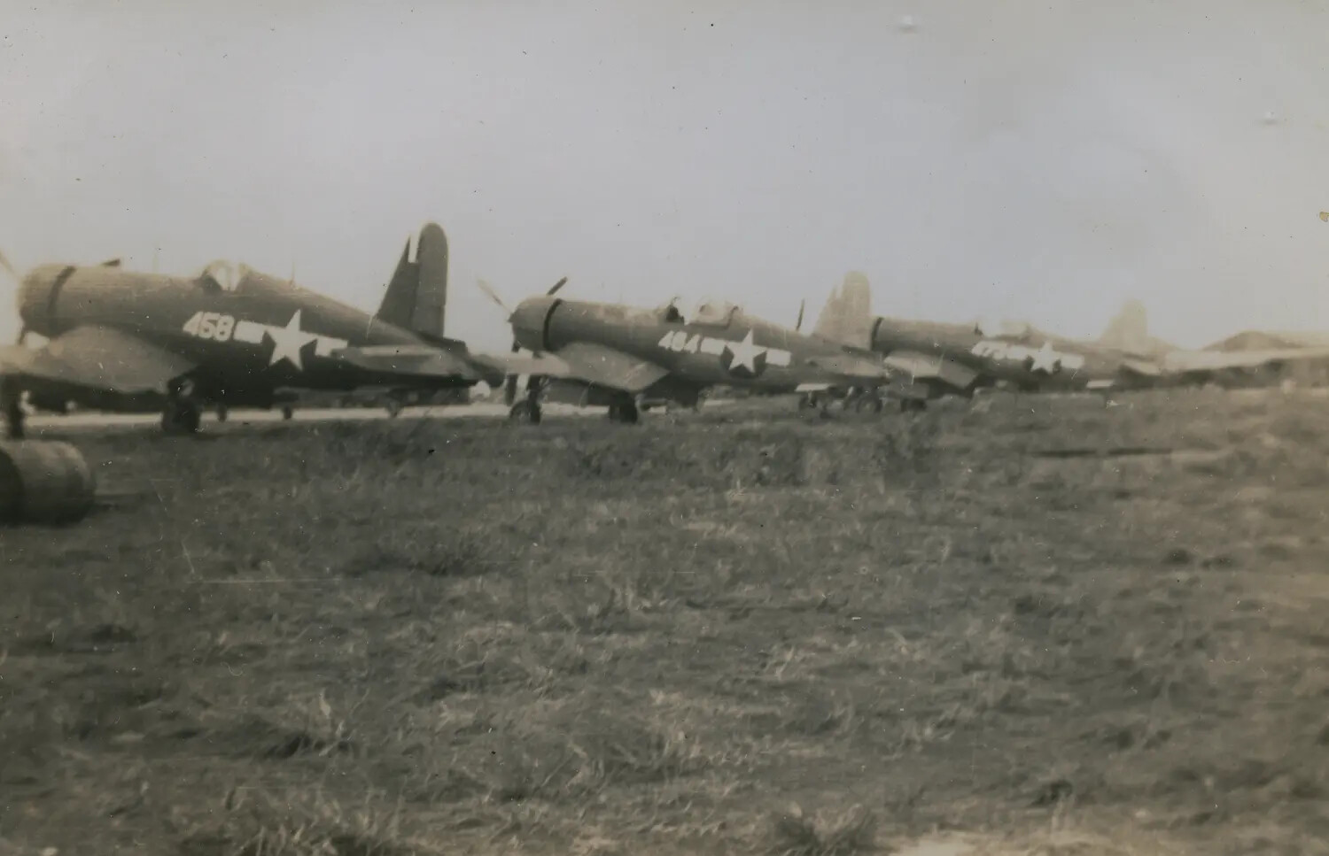 Line of F4U Corsair Fighters Parked on Airfield, WWII Pacific Theater
