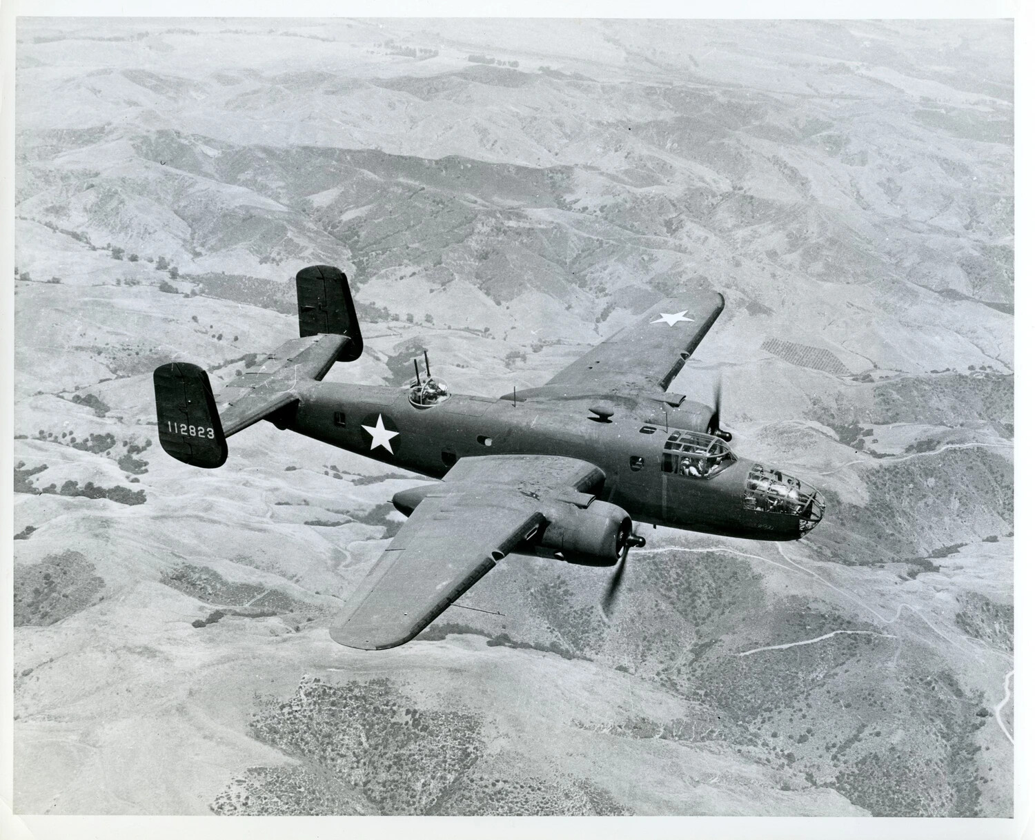 North American B-25 Mitchell Medium Bomber (Serial 112823) in Flight Over Mountainous Terrain