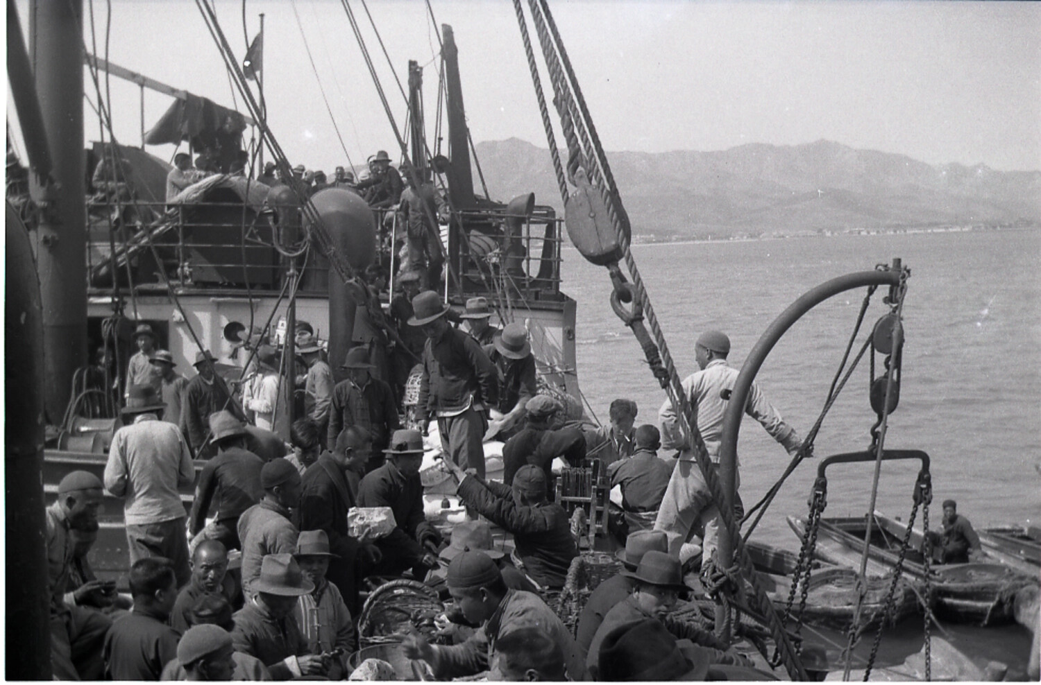 Crowded Cargo Deck with Chinese Passengers and Ship's Derrick, Coastal China