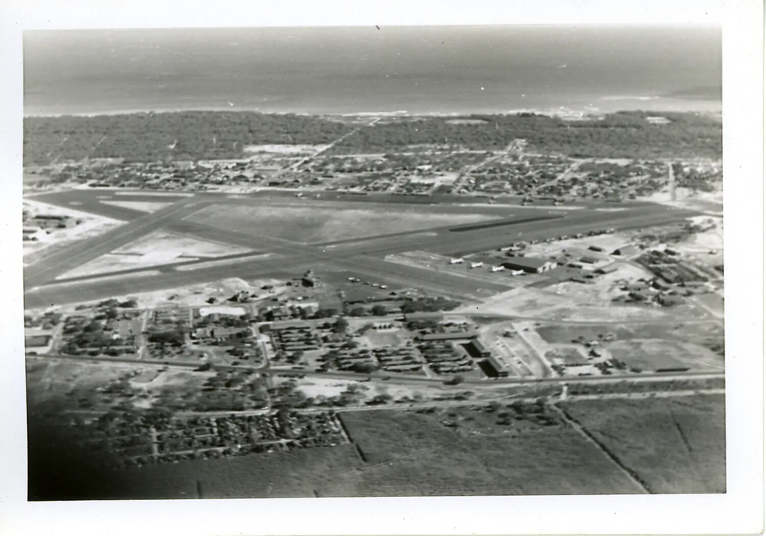 Aerial View of WWII-Era Military Airfield with Crossed Runways, Likely Hawaii