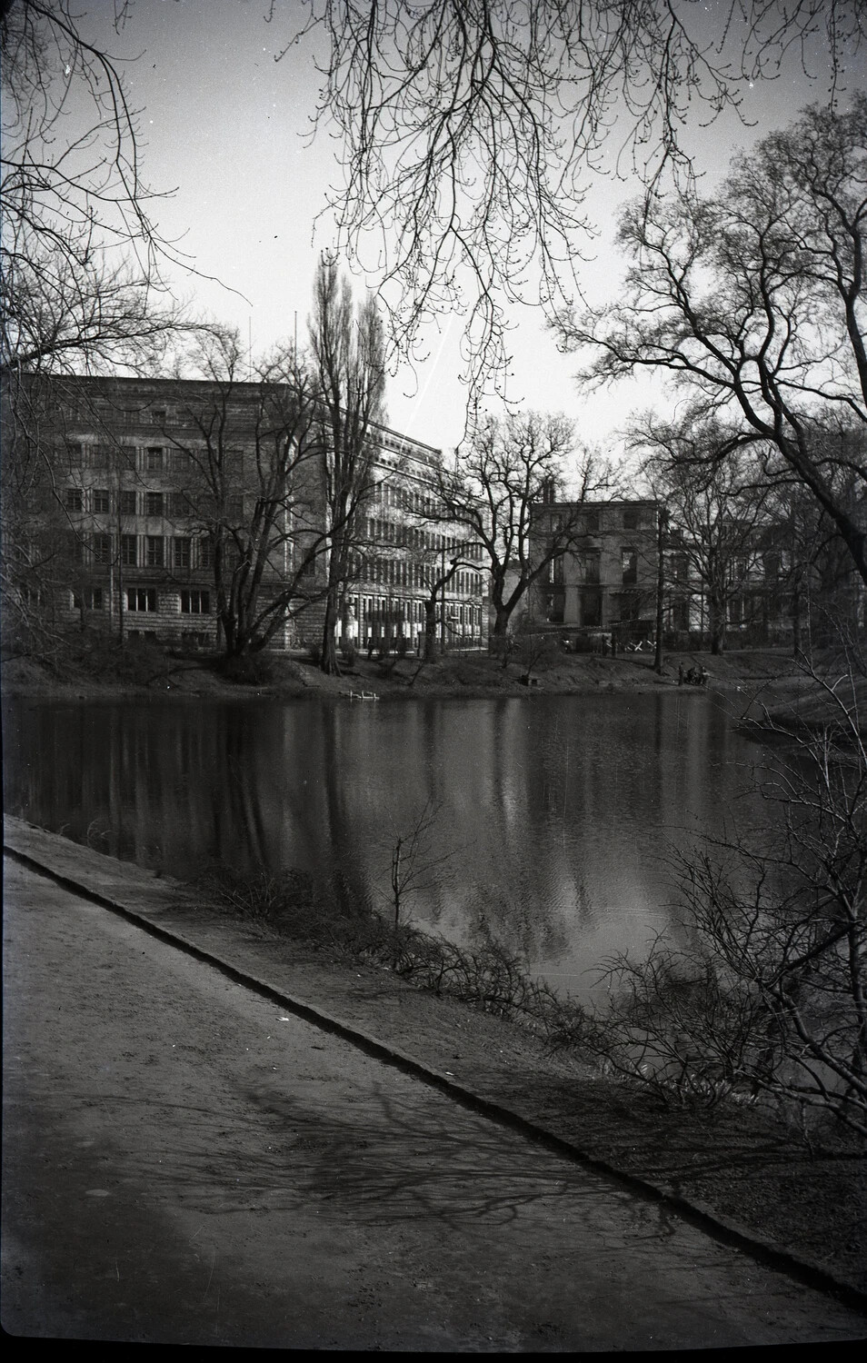 Riverside/Canal View with Damaged Building and Bare Winter Trees, Germany