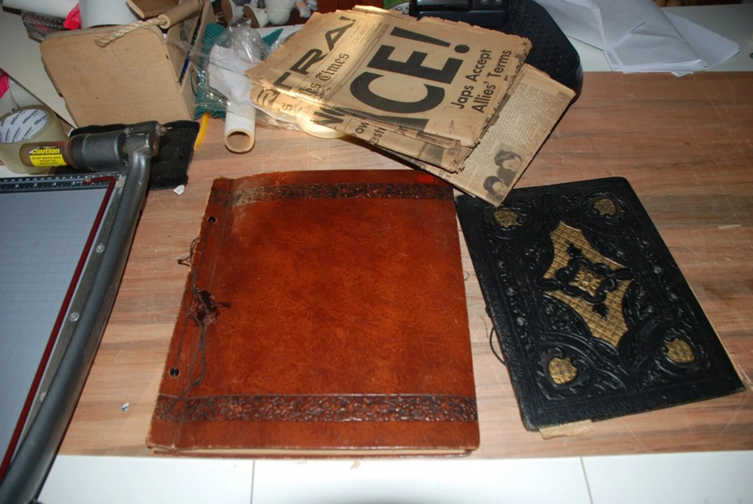 Archival Workspace View: Vintage Photo Albums and V-J Day 'Extra' Newspapers from a WWII Personal Collection