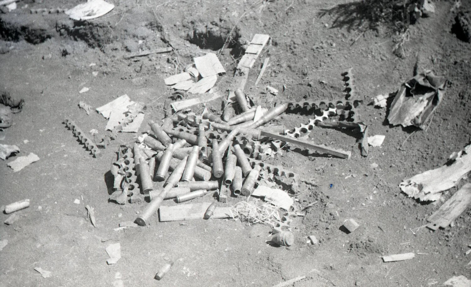 Spent Shell Casings and Ammunition Belt Links at a Fighting Position, Luzon, Philippines, WWII