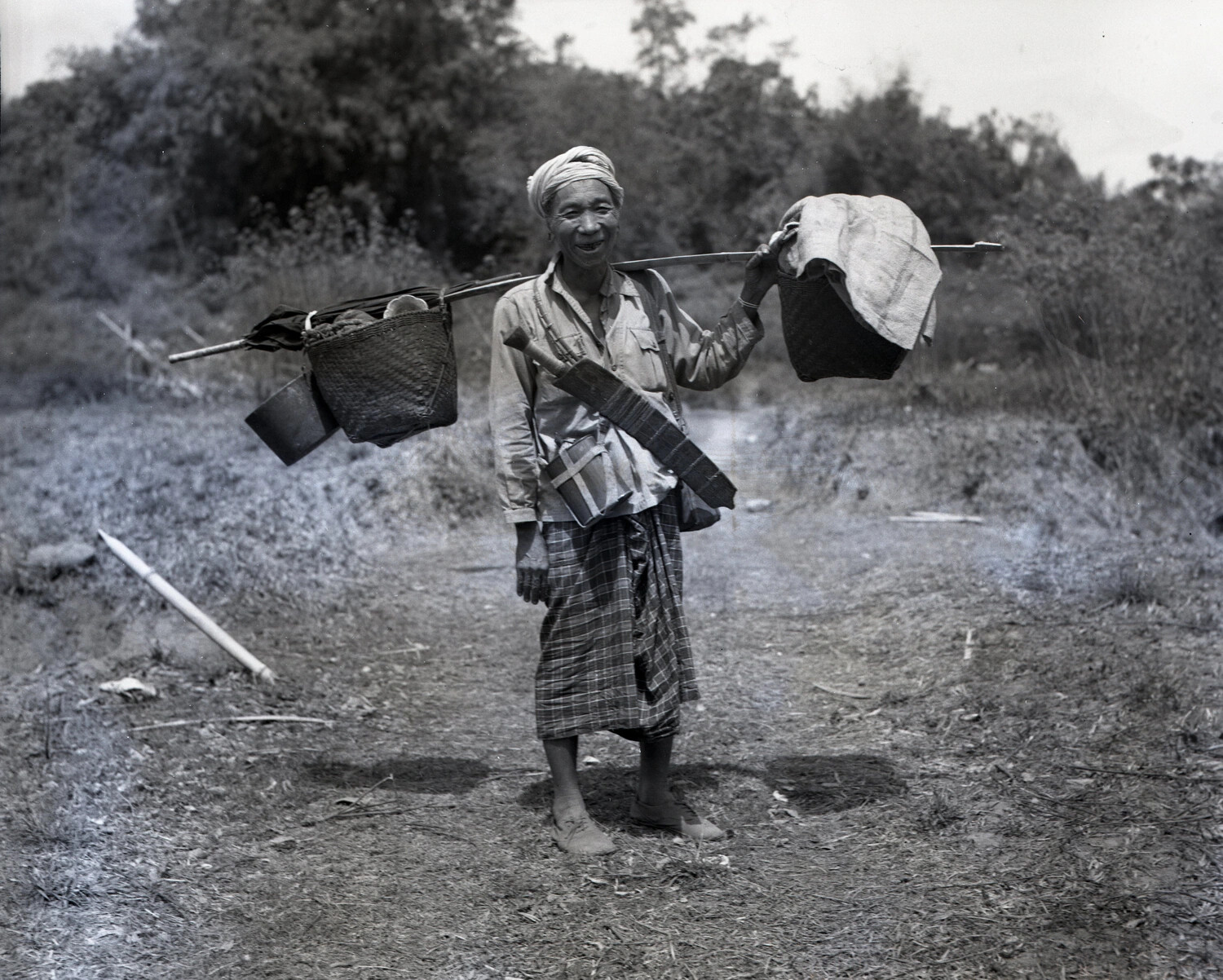 Burmese Man with Shoulder Yoke and Provisions, China-Burma-India Theater, WWII Era