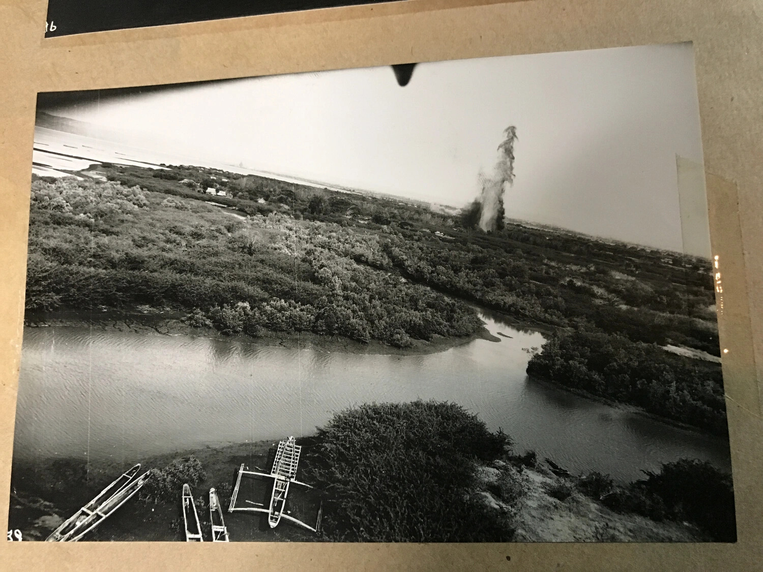 Aerial Photograph of River Estuary with Beached Outrigger Boats and Distant Bomb Strike, Philippines - 312th Bomb Group