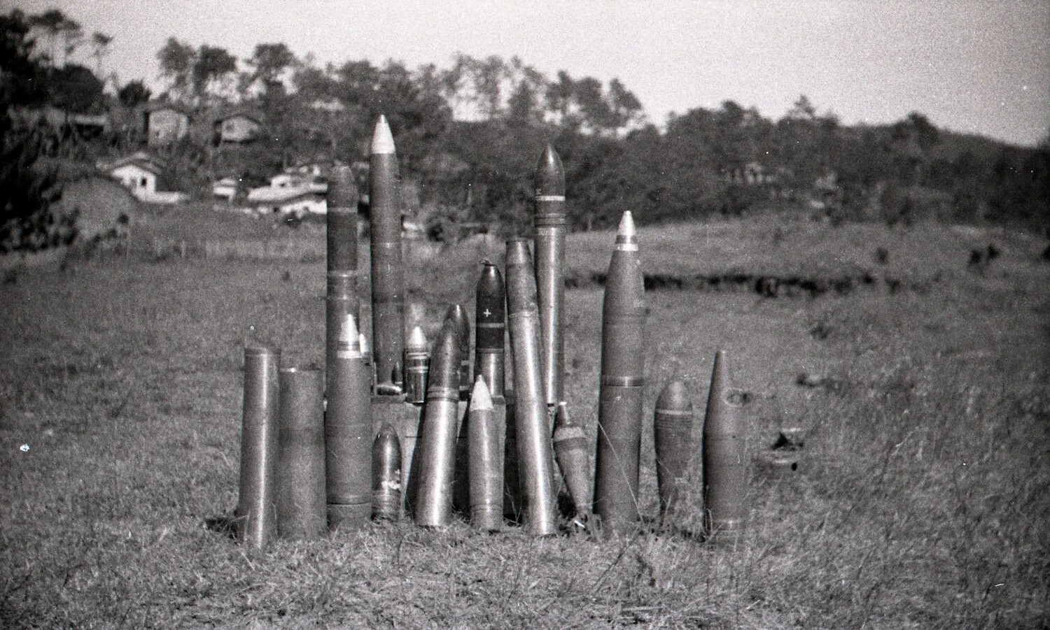Collection of Artillery Shells Displayed in Field near Philippine Village, World War II