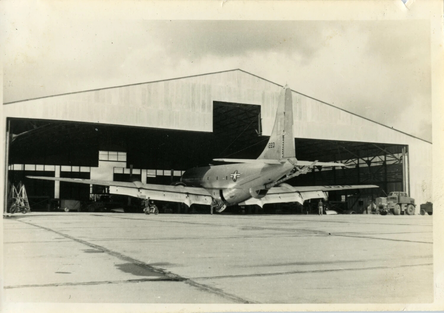 KC-97 Stratofreighter, Tail Number 1223, Parked Before Open Hangar with Ground Support Equipment