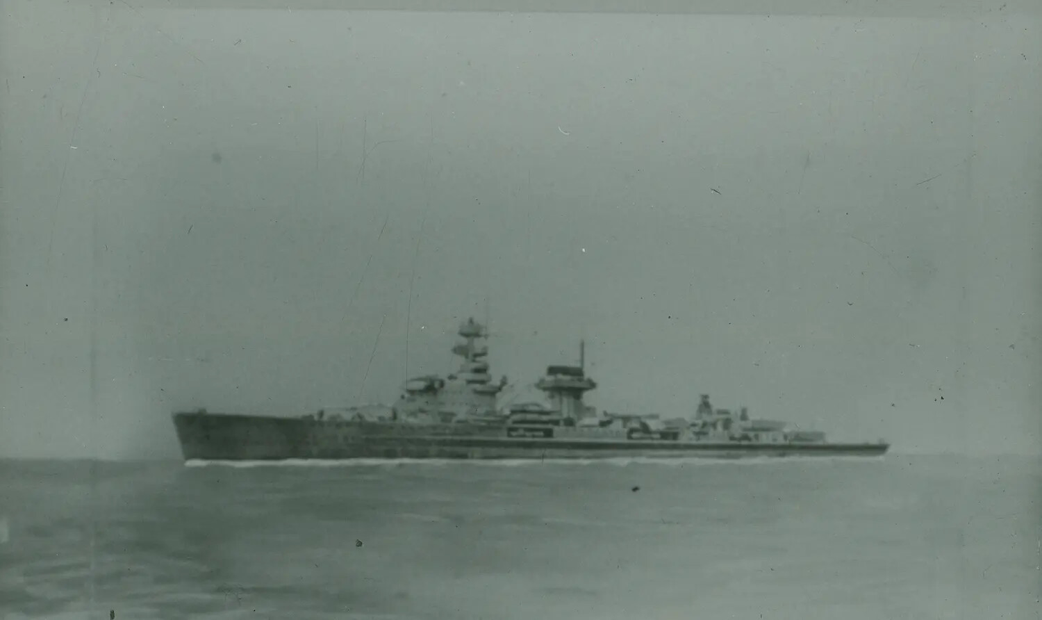 Large World War II-Era Warship (Cruiser or Battleship Type) Underway at Sea