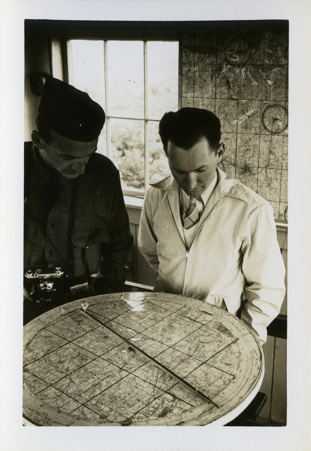 Two Men Examining a Gridded Map Table in a Wartime Operations Room, CBI Theater