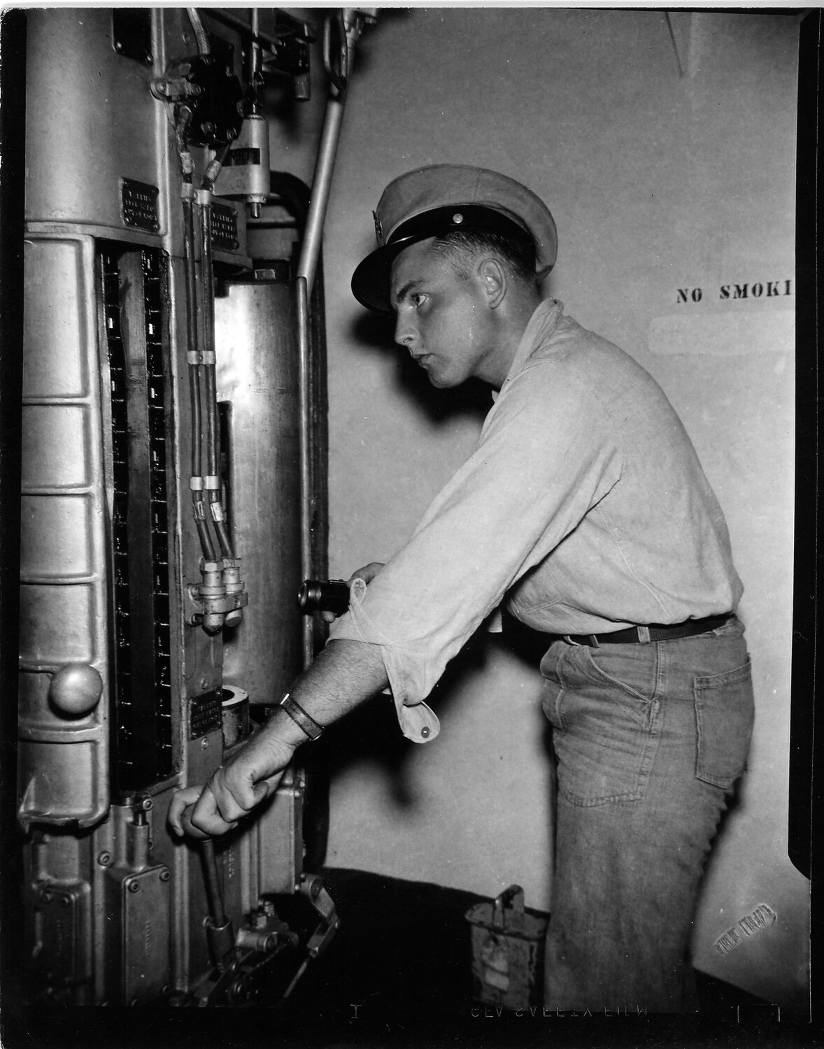 Sailor Inspecting Electrical Switchboard Aboard Ship