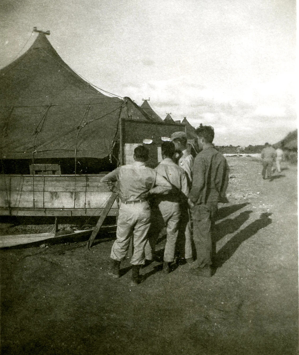 Airmen Reading Squadron Notices Outside Tent Camp, Ie Shima, 345th Bombardment Group