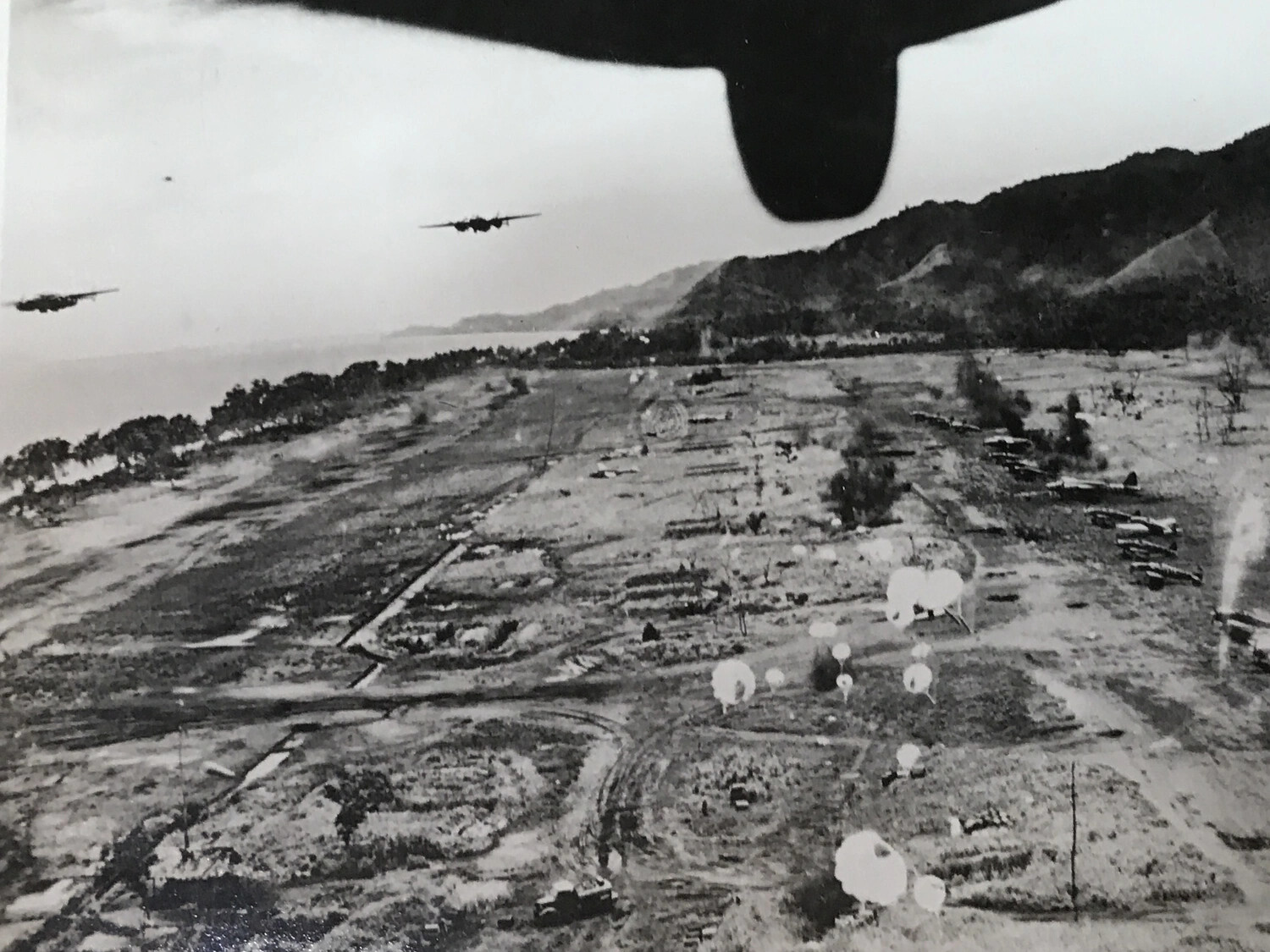 B-25 Mitchells Strafe Japanese Airfield with Parafrag Bombs, New Guinea