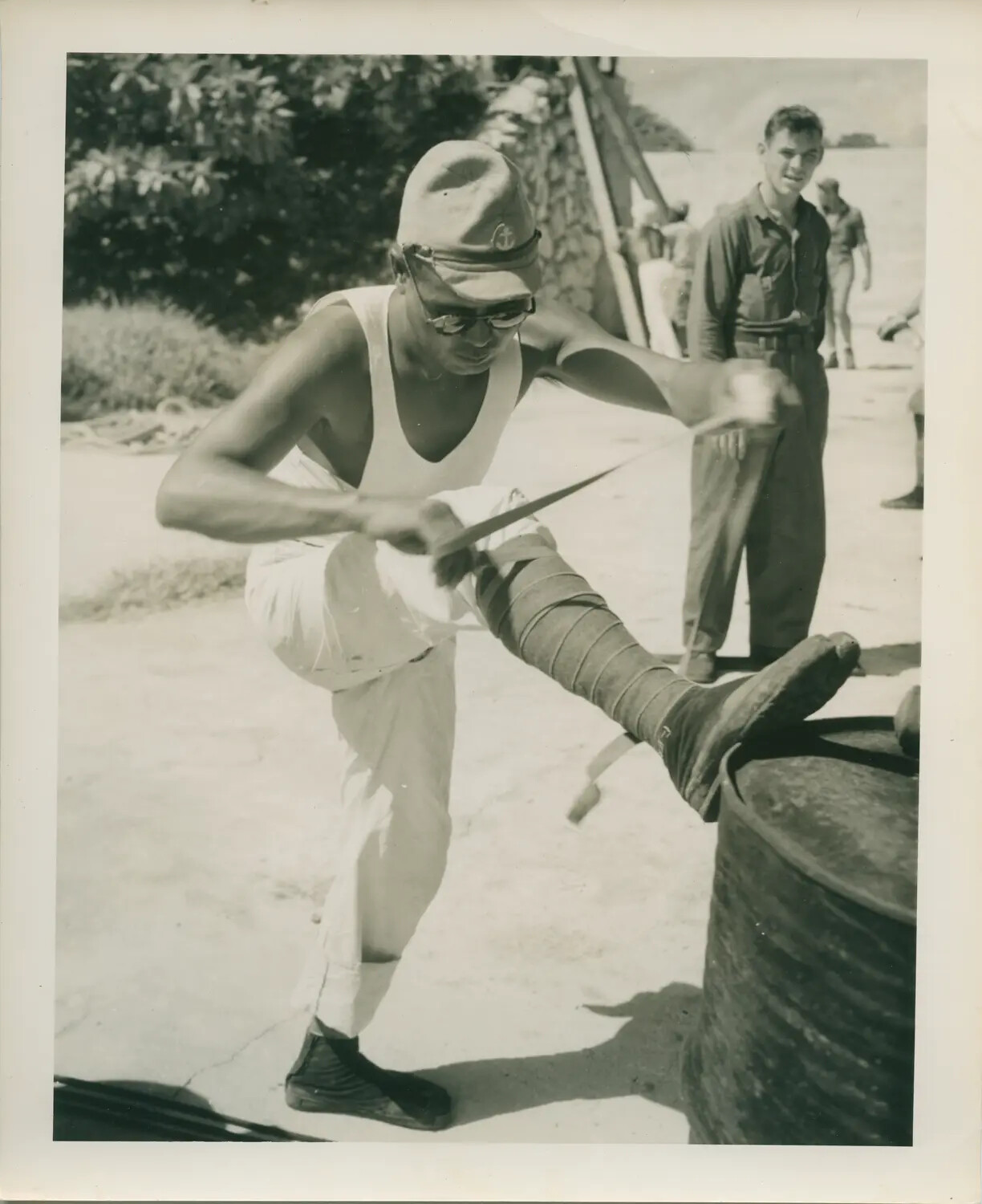 Sailor Cleaning a Large Fish Catch, USS Petrof Bay (CVE-80) Personnel, Pacific Theater, WWII