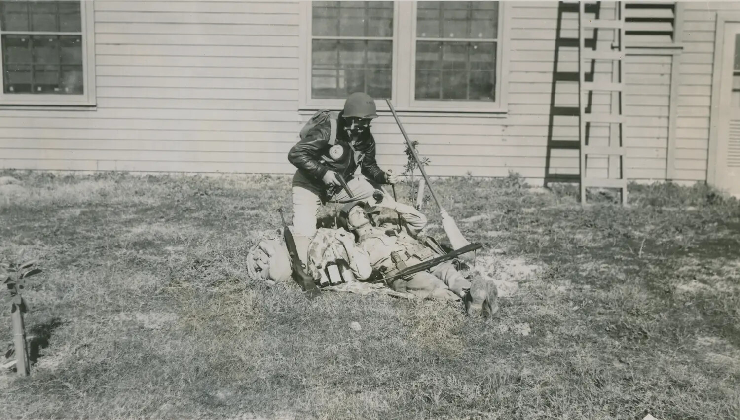 Gas Mask Training Exercise with Simulated Casualty, WWII Era