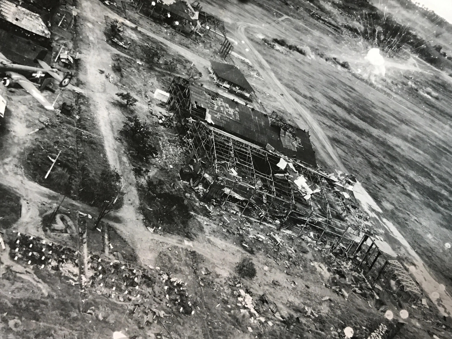 Bomb Burst and Hangar Wreckage During Airfield Strike, Pacific Theater