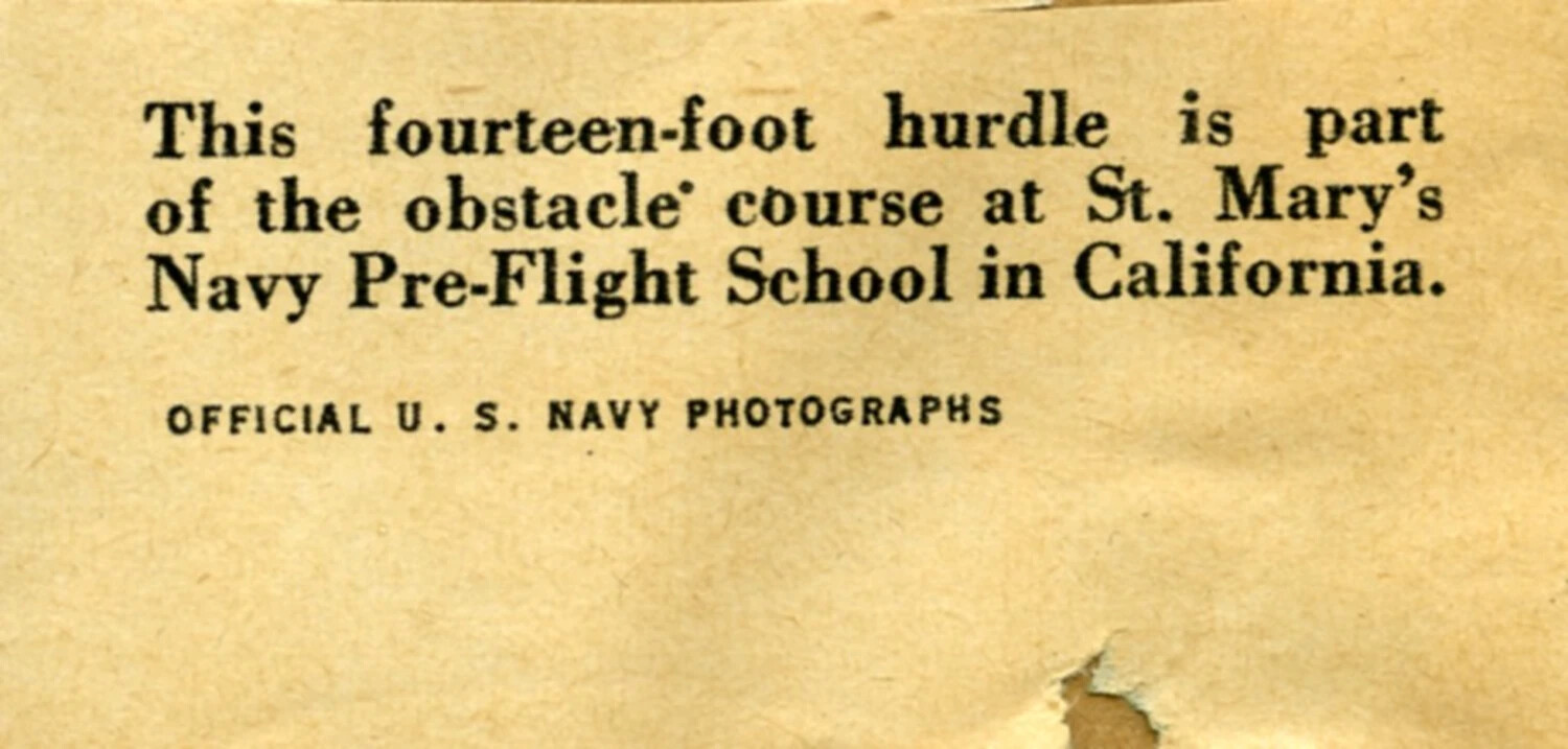 Printed Caption Fragment, 'Official U.S. Navy Photographs' — St. Mary's Navy Pre-Flight School Obstacle Course