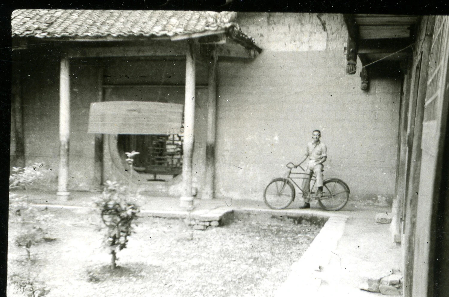 Man with Bicycle in Courtyard of Traditional Building, Possibly China-Burma-India Theater (Misfiled Among Vietnam/USS Ticonderoga Materials)