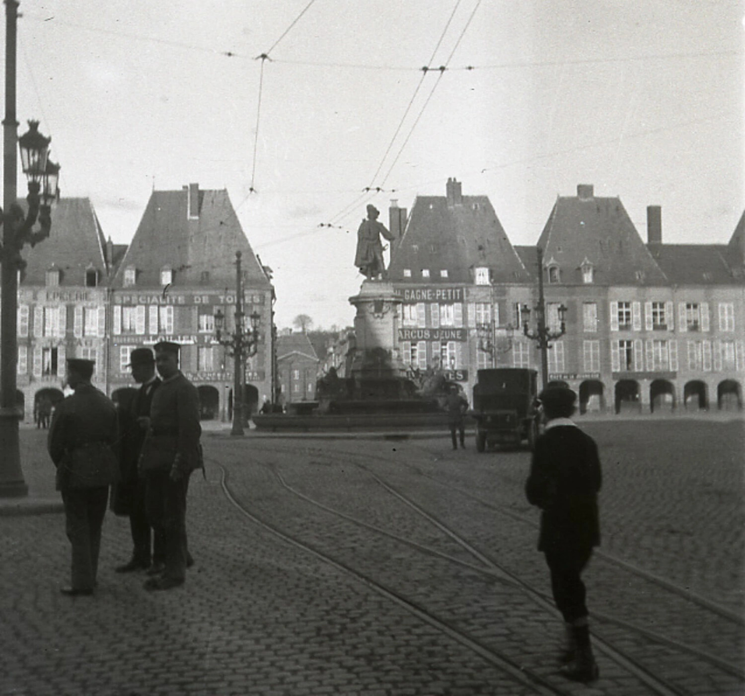 Town Square with Monument and Uniformed Figures, World War I Era (French-Language Shopfronts)