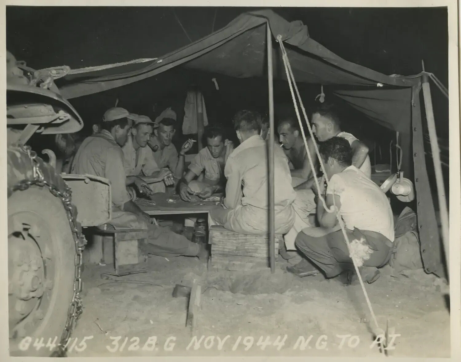 312th Bombardment Group Servicemen Playing Cards Under Tent at Night, November 1944