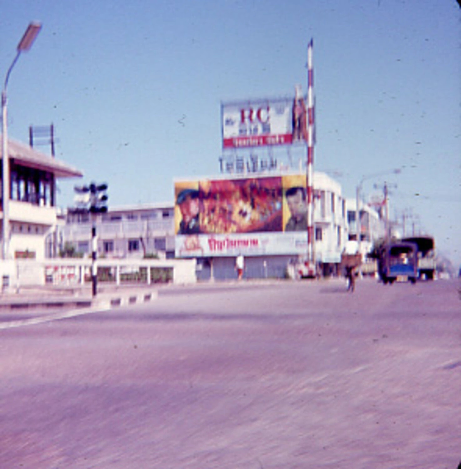 Roadside Cinema Billboard and Empty Boulevard, Southeast Asian Town, Vietnam War Era