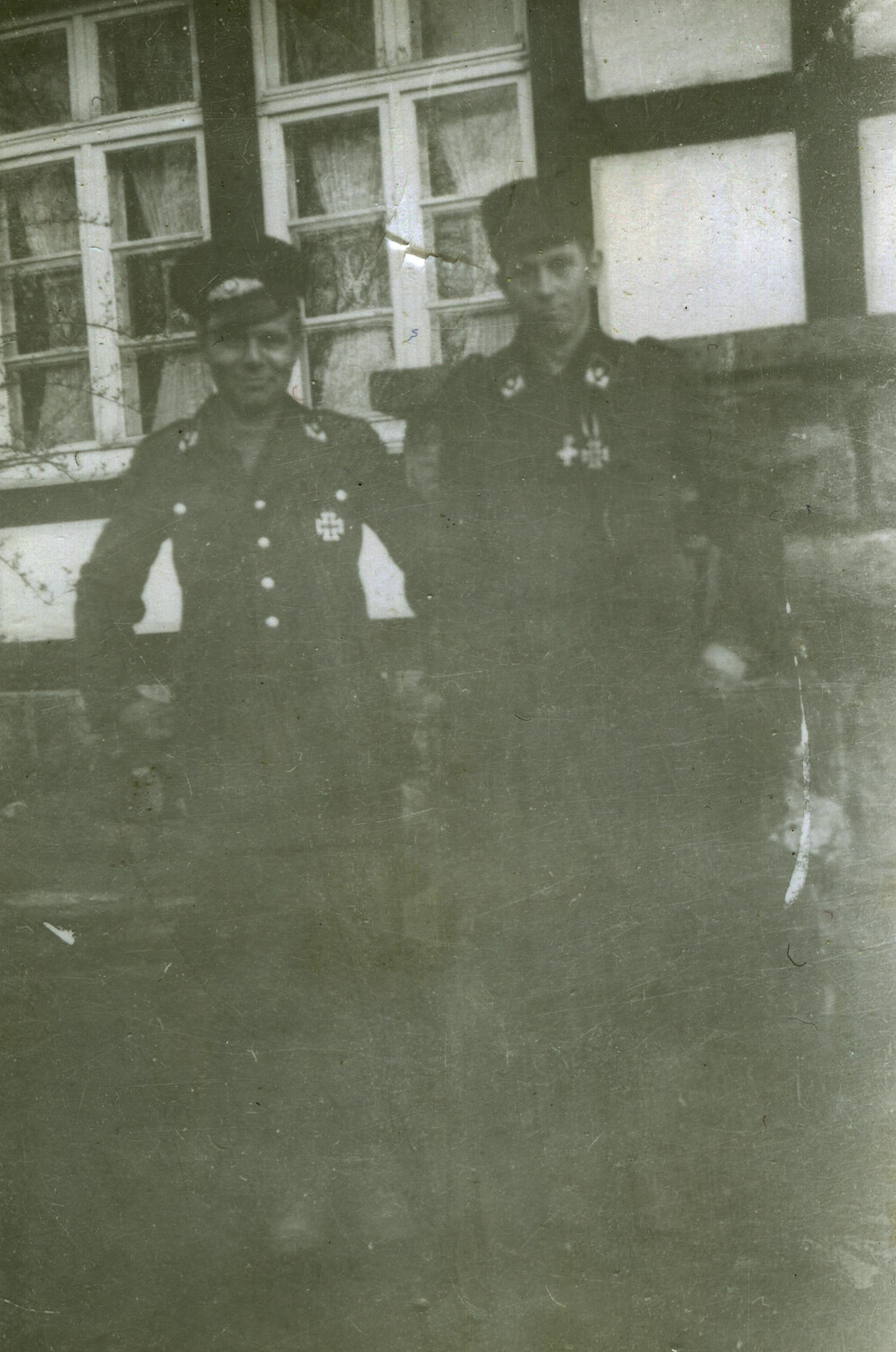 Two Uniformed Men in Dark Service Dress Before Half-Timbered House, Germany