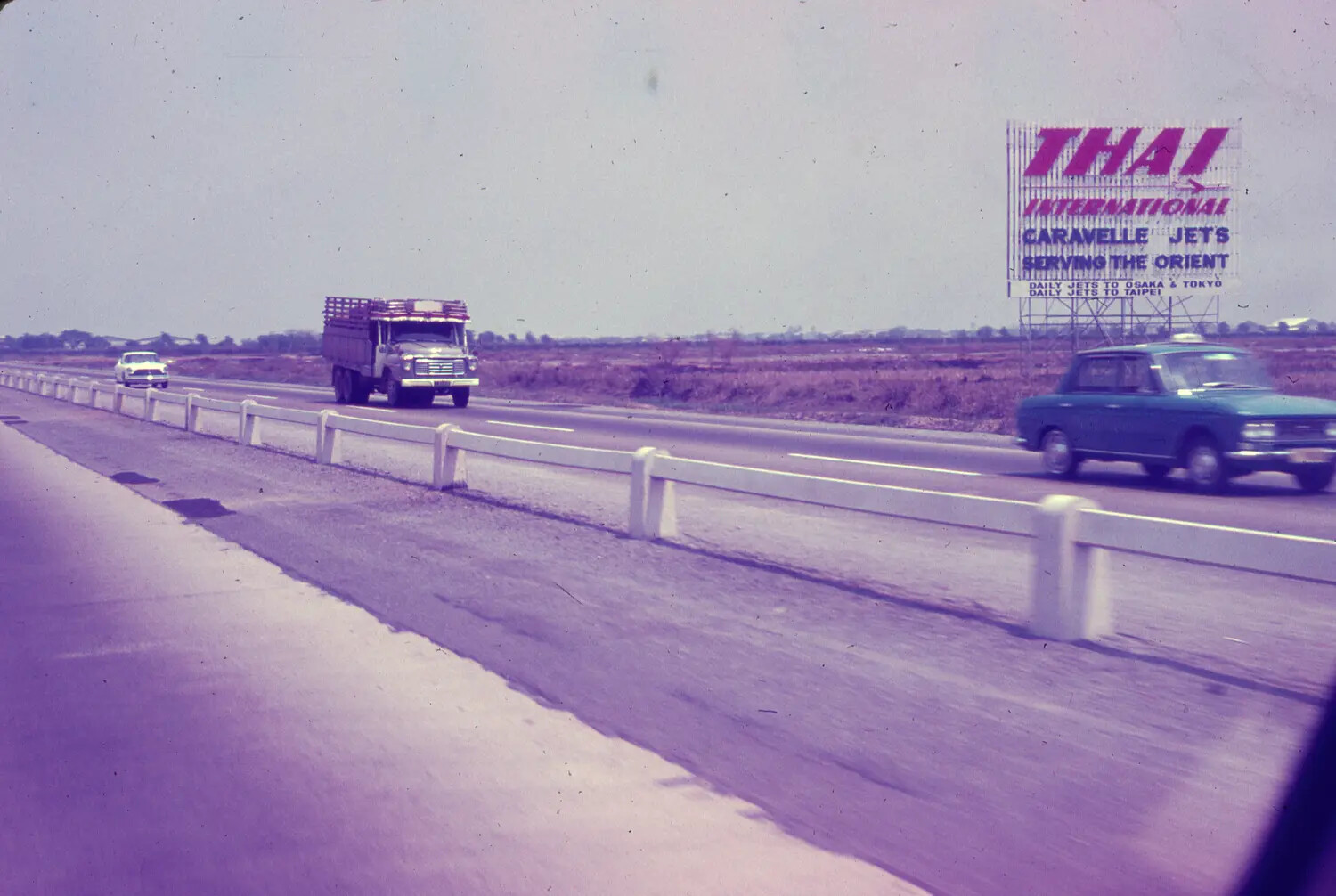 Highway Scene with Thai International Airlines Billboard, Southeast Asia, 1965