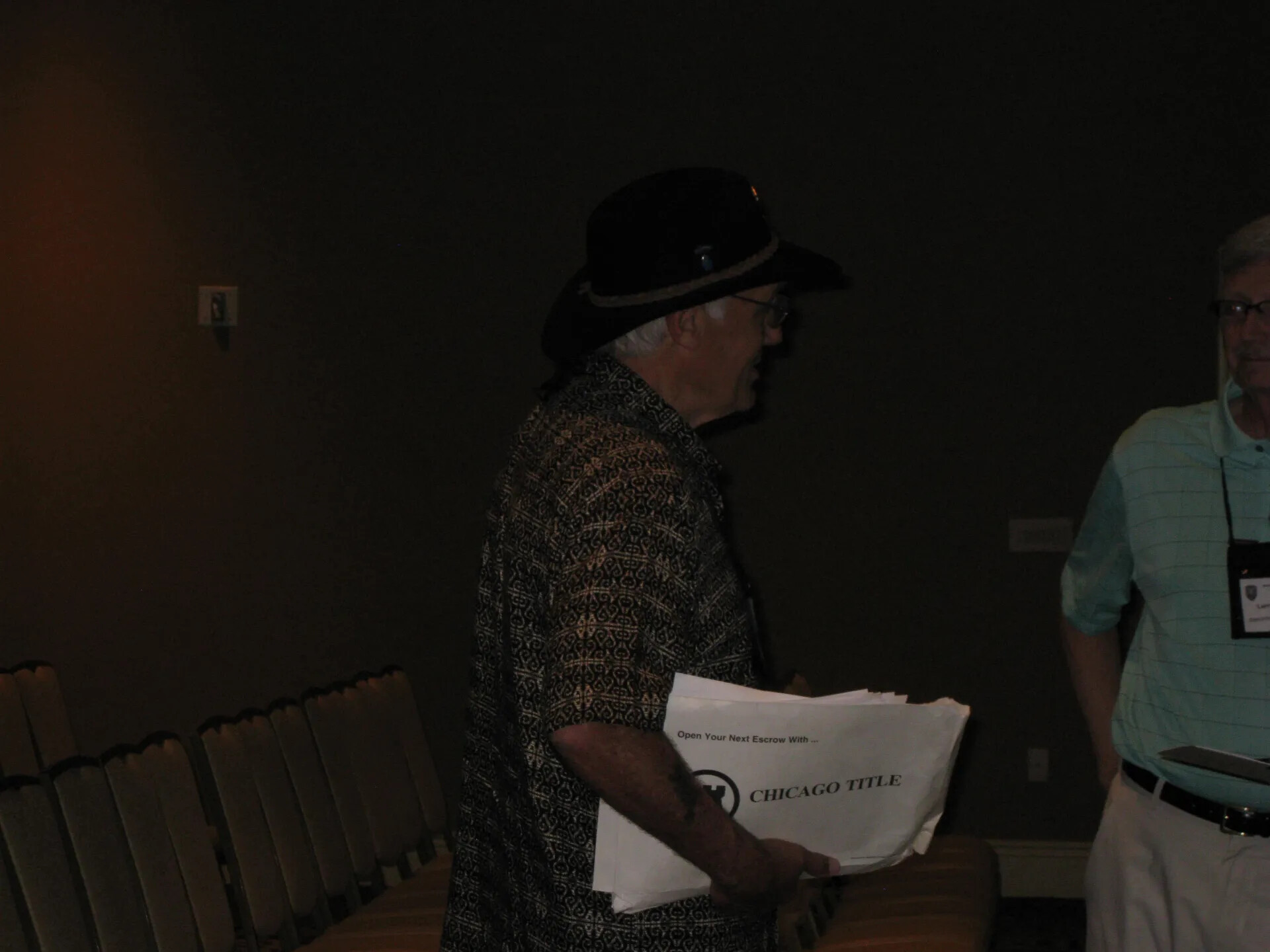 Attendee in a Wide-Brimmed Hat Carrying Reunion Papers, Special Operations Association Reunion XXXVII, Las Vegas, 2013
