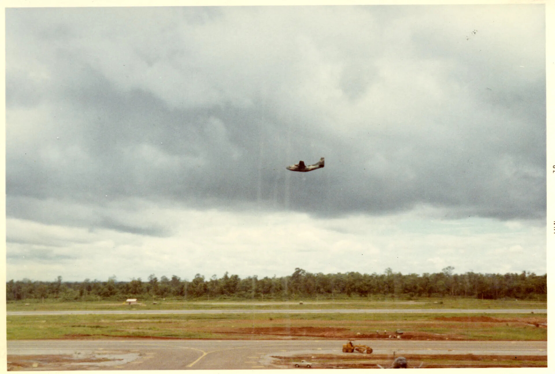 C-123 Provider in Flight Over NKP RTAFB Under Storm Clouds