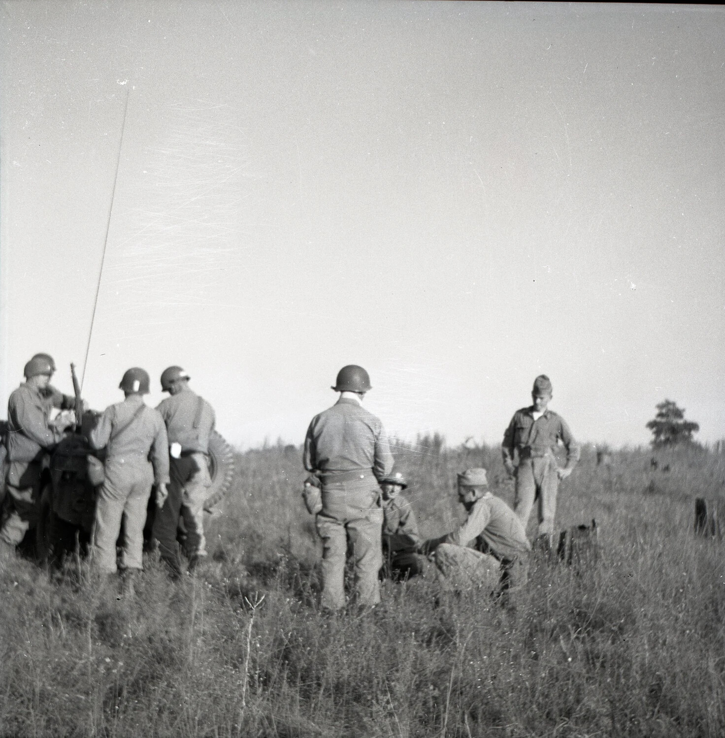 Soldiers Gather Around Radio Equipment During Field Training Exercise
