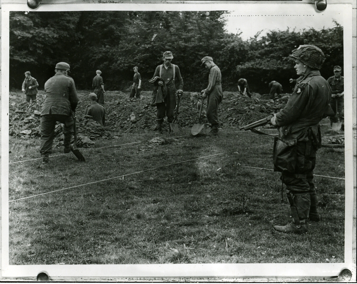 German Prisoners of War Digging Graves Under American Guard, Normandy, France, 1944