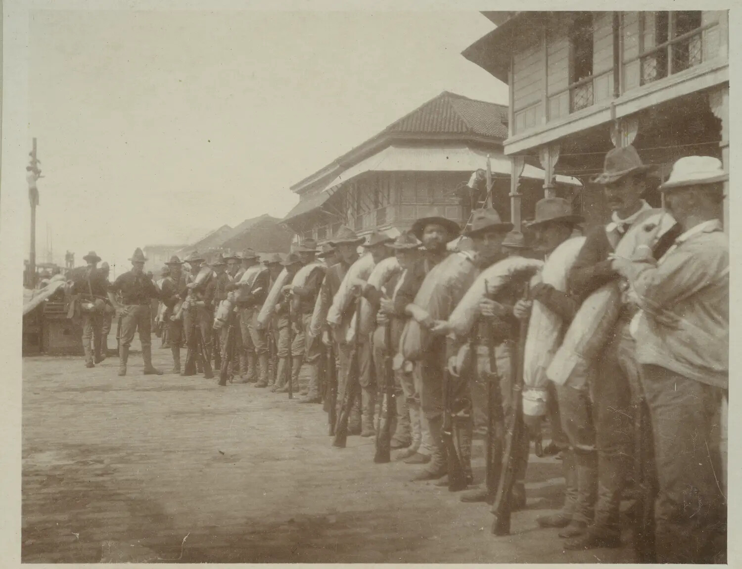 American Infantry Formation with Blanket Rolls Along a Colonial Street, Philippine-American War, c. 1898-1902