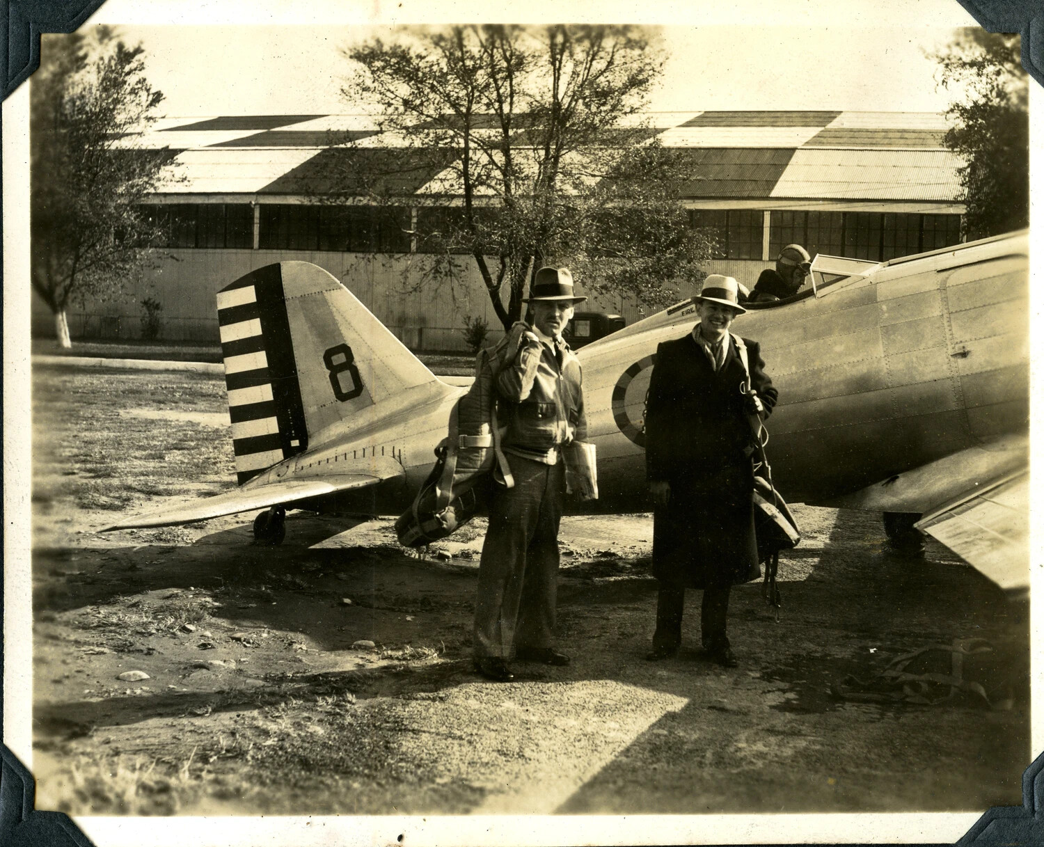 U.S. Army Air Corps Pursuit Aircraft with Pilot and Two Civilian-Dressed Men on Airfield Ramp, Pre-WWII Era