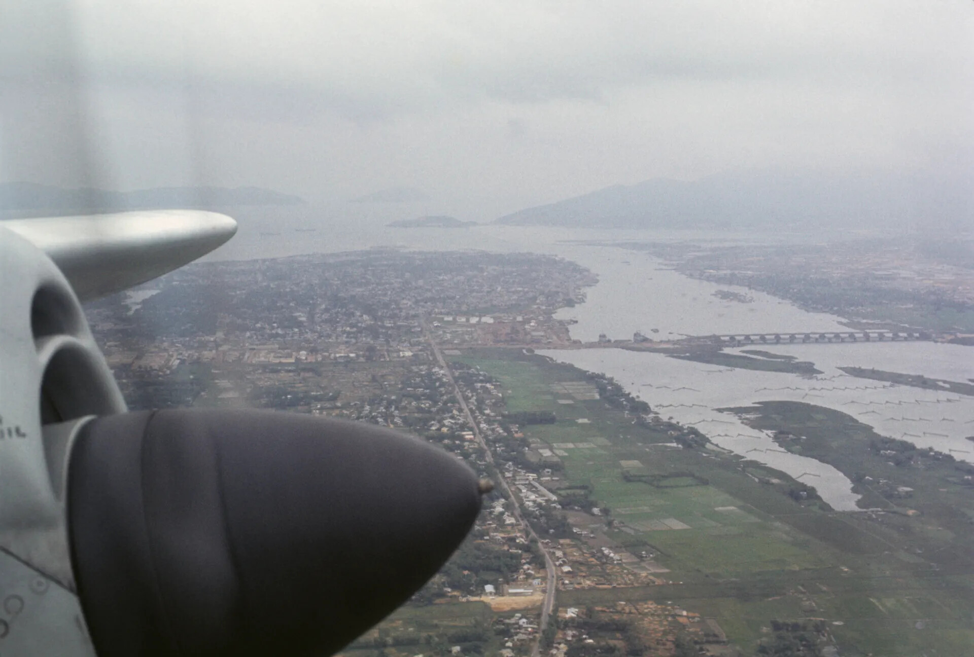 Aerial View of Coastal Vietnamese City and River Estuary from Aircraft Window