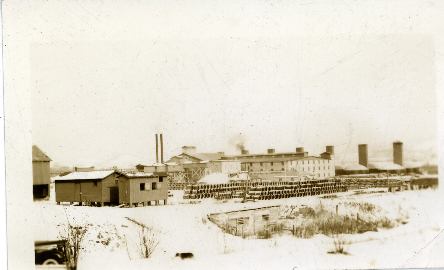 Snow-Covered Industrial Complex with Multiple Chimneys, Labeled 'WWII German Concentration Camp'