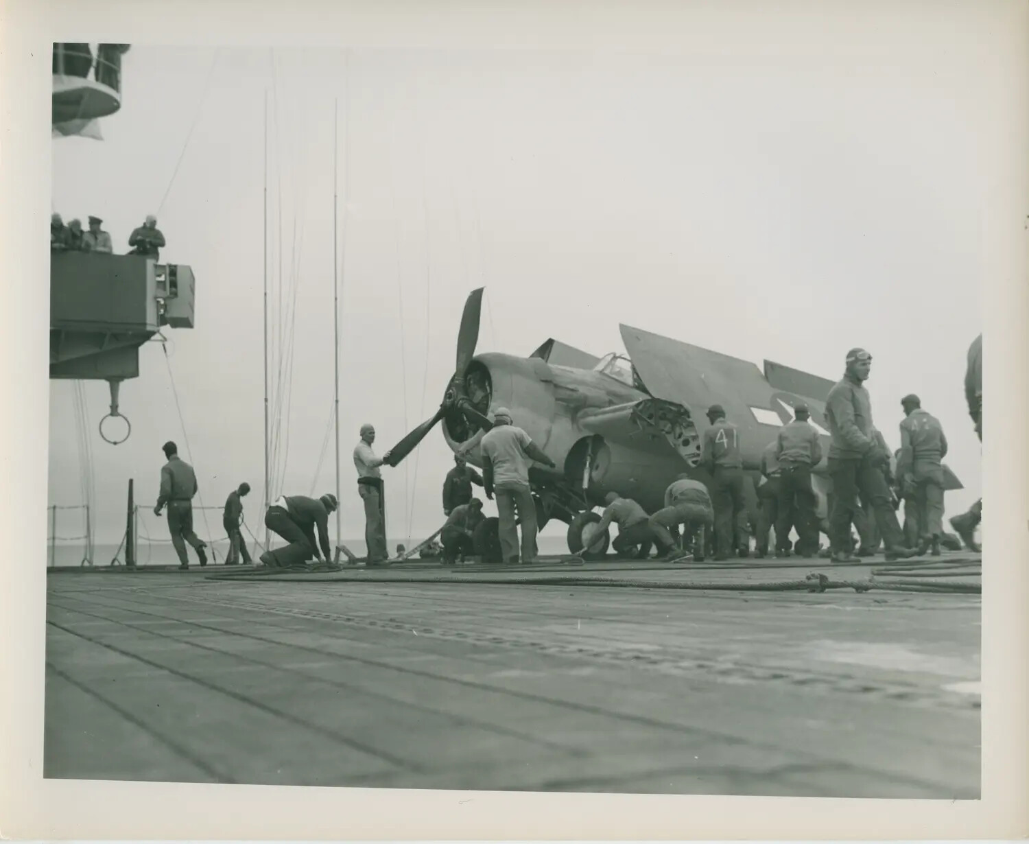 FM-2 Wildcat with Wings Folded, Flight Deck Crew at Work, USS Petrof Bay (CVE-80)