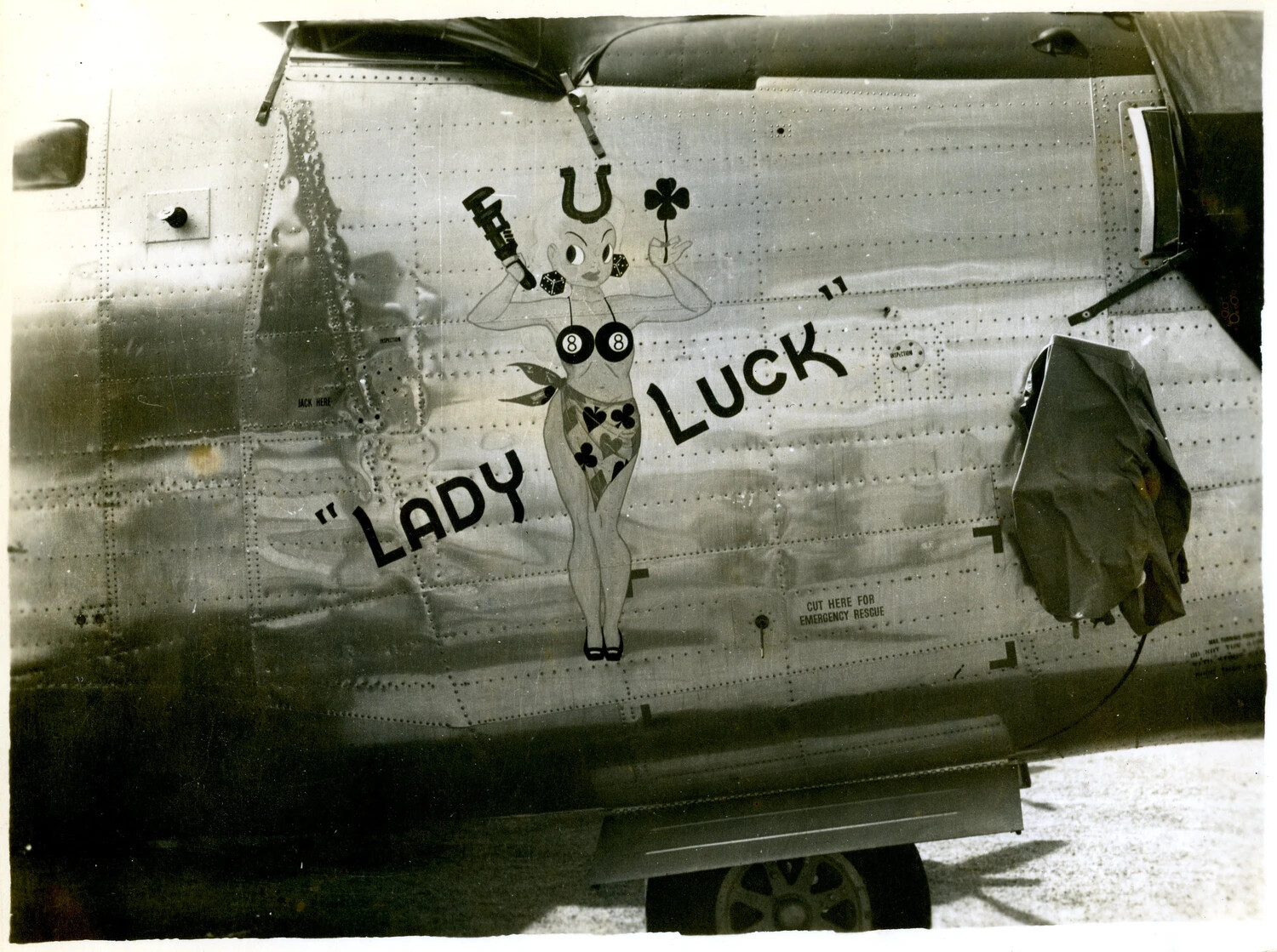 Nose Art "Lady Luck" with Gambling Motif on U.S. Military Aircraft Fuselage, WWII Pacific Theater